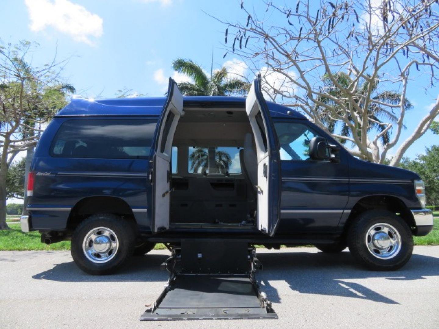 2011 Dark Blue /Gray Ford E-Series Wagon E-350 XLT Super Duty (1FBNE3BS4BD) with an 6.8L V10 SOHC 20V engine, located at 4301 Oak Circle #19, Boca Raton, FL, 33431, (954) 561-2499, 26.388861, -80.084038 - You are looking at a Gorgeous 2011 Ford Econoline E350 XLT Norcal Max High Top Handicap Wheelchair Conversion Van with 6.8L V10, 15K Original Miles, 9 Inch Lowered Floor, Braun UVL Side Entry Wheelchair Lift, Remote Control Power Side Entry Doors, Expanded Side Entry Doors, Q Straint Tie Down, Syste - Photo#0